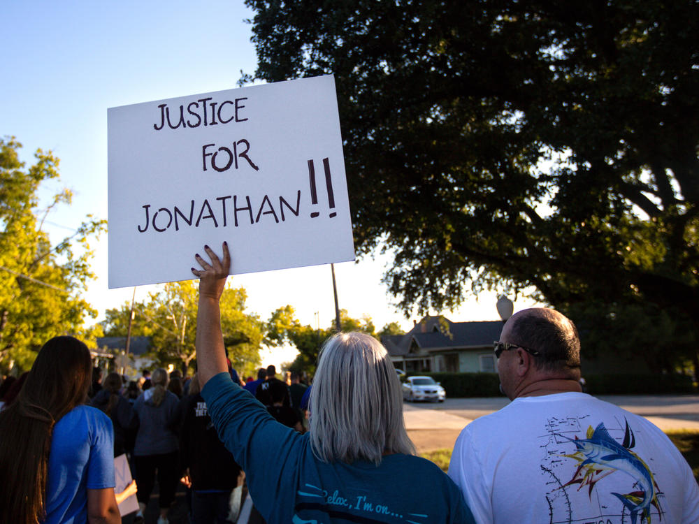 People gather for a march, rally and candlelight vigil in honor Jonathan Price in Wolfe City, Texas, on Monday. Wolfe City police officer Shaun Lucas has been charged in relation to the fatal shooting.