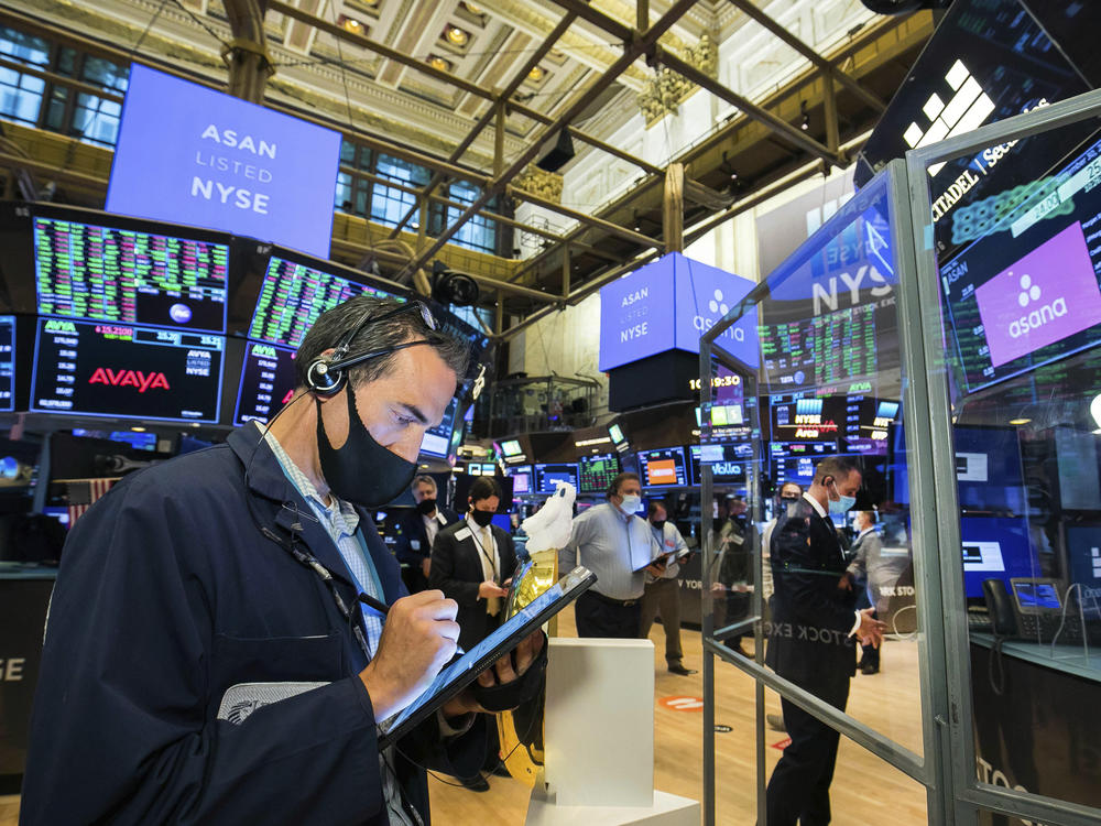 Traders gather on the New York Stock Exchange trading floor on Sept. 30. Major U.S. stock indexes rose Wednesday after President Trump said he'd be willing to consider economic relief measures. Trump earlier had called off such talks with lawmakers.