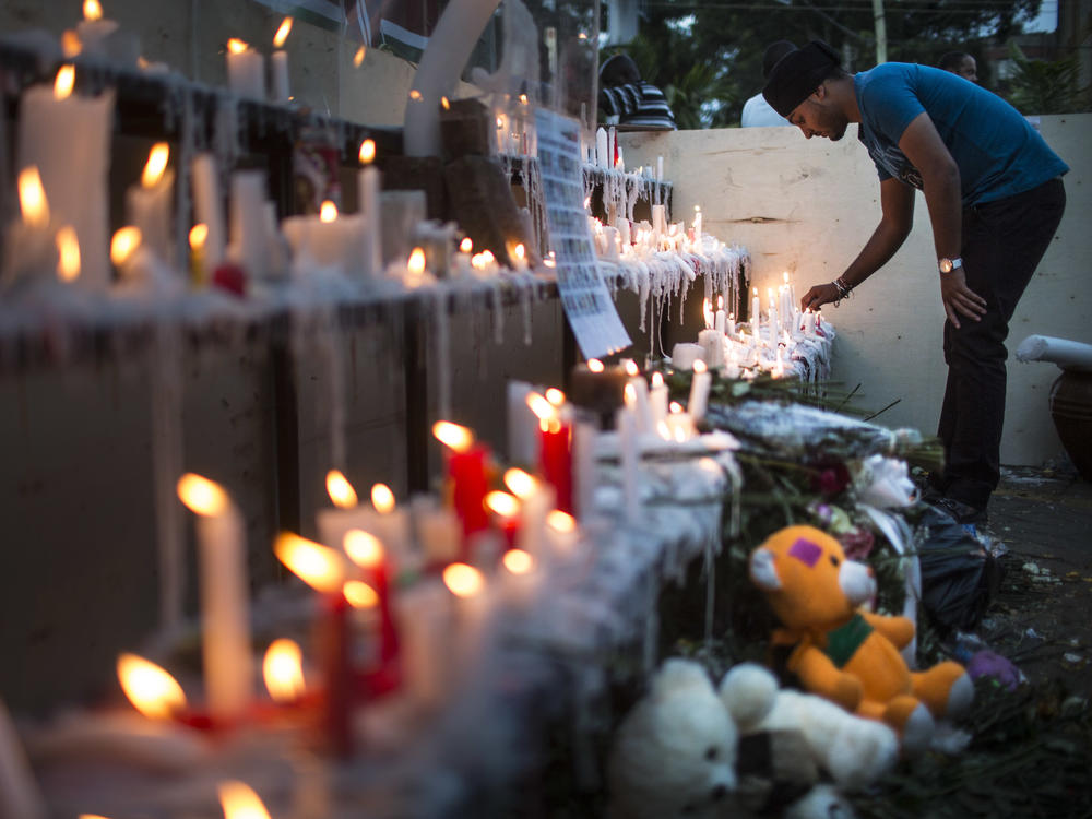 People light candles for the victims of the attack outside the Westgate Shopping Centre on September 29, 2013 in Nairobi, Kenya. Two men were found guilty Wednesday for aiding the attack.