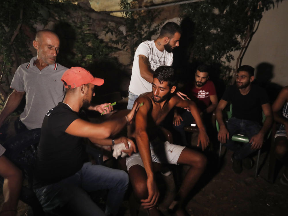 Ibrahim Lasheen, 22, is brought back to his hometown of Tripoli, Lebanon, in September. A U.N. naval force rescued him after he swam for 18 hours to seek help for dozens of fellow passengers crammed on a small fishing boat that ran out of fuel as it headed to Cyprus.