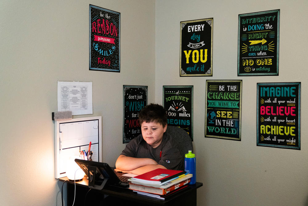 Niko sits at the virtual learning workspace that Barrera set up in his bedroom.