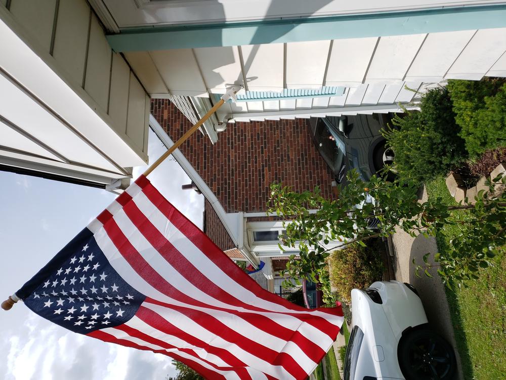 An Vu, the son of Vietnamese immigrants, sent NPR a photo of the U.S. flag he flies next to his garage. He says he misses the time after the Sept. 11 attacks when the country felt more unified.