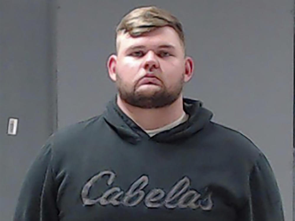 Former Wolfe City, Texas, police Officer Shaun Lucas, shown here in a booking photo, has been charged with murder in the fatal shooting of a Black man at a convenience store.