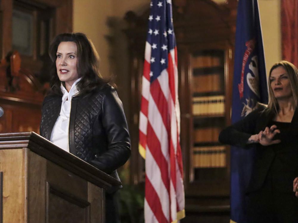 Michigan Gov. Gretchen Whitmer addresses the state during a speech Thursday in Lansing. Thirteen members of two militia groups face criminal charges after allegedly plotting to kidnap Whitmer.