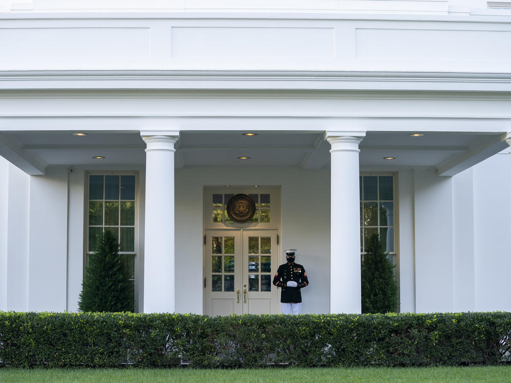 A Marine is posted Thursday outside the West Wing of the White House, signifying the president is in the Oval Office. President Trump's physician said that he could return to public engagements as soon as Saturday.
