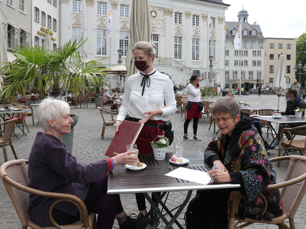 Outdoor dining in Bonn, Germany. Indoor dining is riskier than outdoor meals, experts say. Outdoor air can disrupt viral particles that have been expelled.