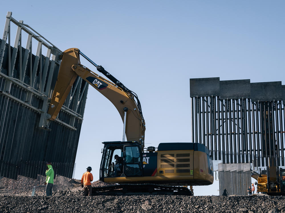 Fisher Industries workers move sections on May 24, 2019 in Sunland Park, N.M., near International Boundary Monument No. 1 where New Mexico, Texas and Mexico come together.