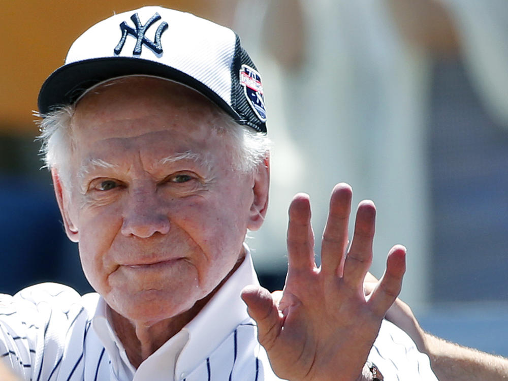 Former New York Yankees pitcher Whitey Ford, shown here waving to fans in 2016, has died at the age of 91.