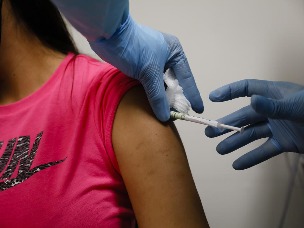 A volunteer received an injection as part of a clinical trial for a COVID-19 vaccine at Research Centers of America in Hollywood, Fla. Studies of vaccines backed by Operation Warp Speed have enrolled tens of thousands of people in a matter of months.