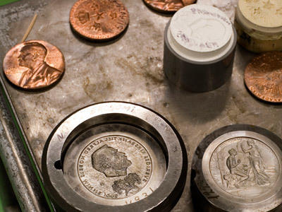 The Nobel Prize gold medal during manufacture at the Swedish Mint. Each laureate receives the medal, which has the likeness of Alfred Nobel on its face.