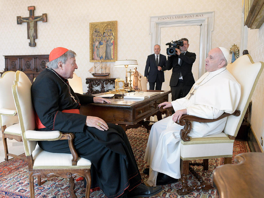 Pope Francis (right) sits at a table with Cardinal George Pell at the Vatican, on Monday. The pope warmly welcomed the cardinal for a private audience in the Apostolic Palace after the cardinal's sex abuse conviction and acquittal in Australia.