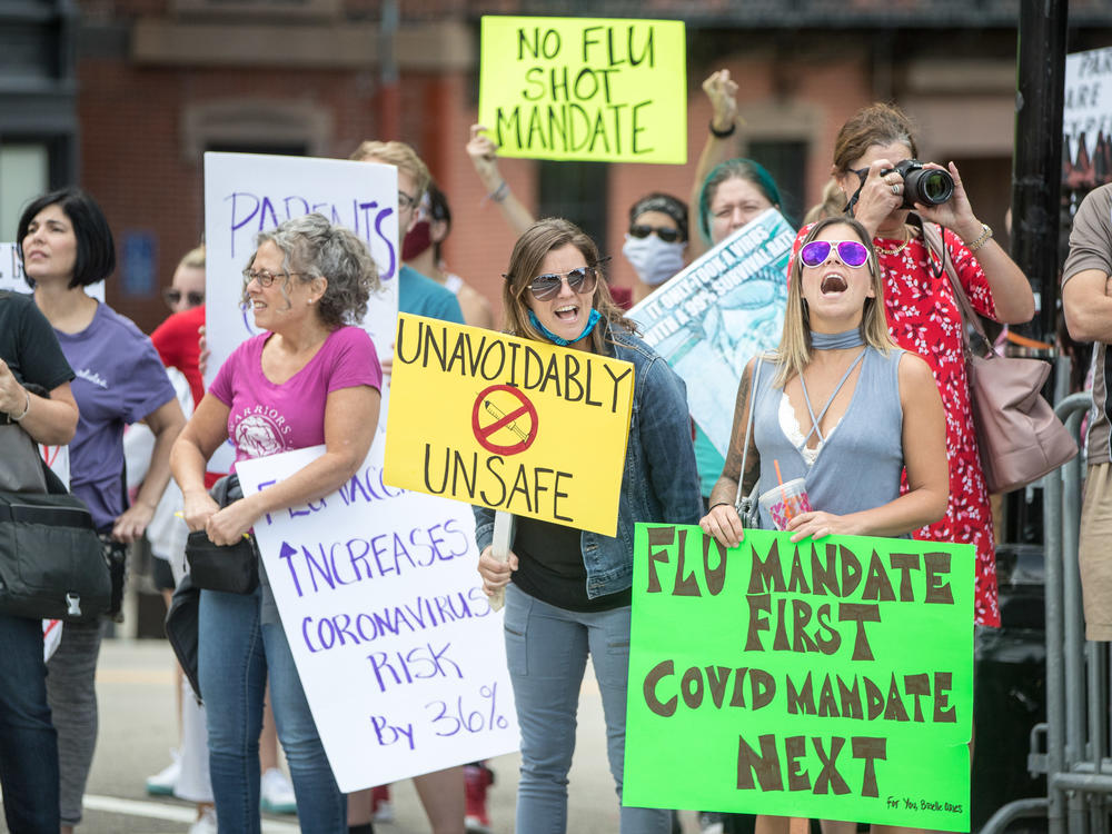 Anti-vaccine activists protested at the Massachusetts State House in August against Governor Charlie Baker's mandate that all students enrolled in child care, pre-school, K-12, and post-secondary institutions must receive the flu vaccine this year.