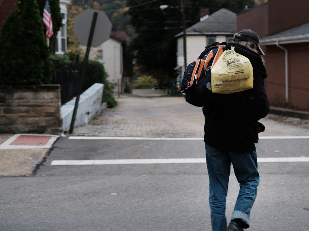 A homeless man walks downtown in East Liverpool, Ohio. Efforts to register homeless voters in the state have relied on churches and shelters volunteering to receive mail-in ballots for people with no permanent address.