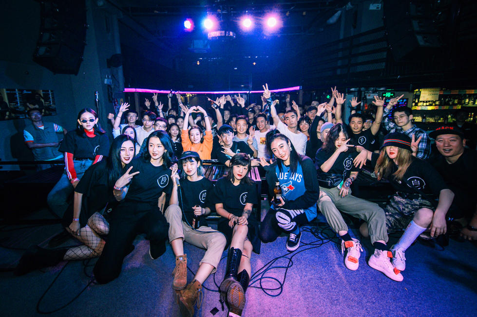 Members of the Bad Girls rap group, which was started by Deng Ge, pose with audience members at a pre-pandemic hip-hop party. Now that the coronavirus is under control in Wuhan, audiences are once again gathering for concerts.