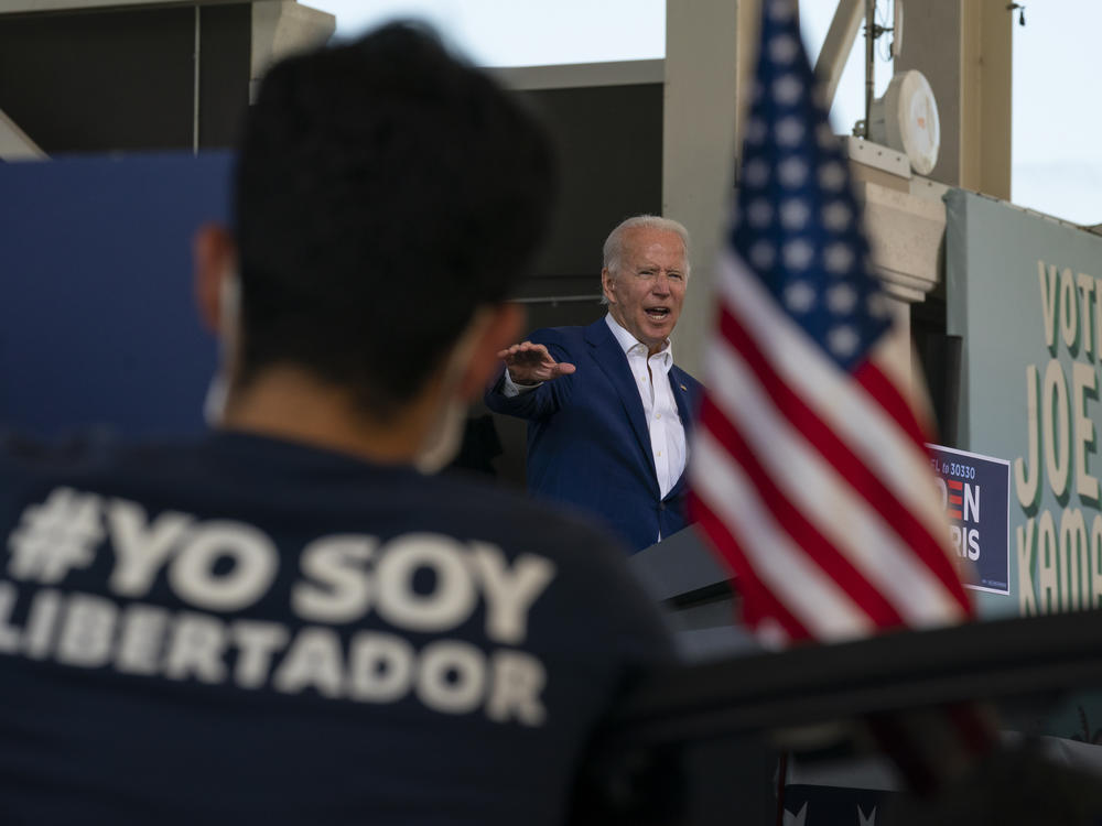 Democratic presidential nominee and former Vice President Joe Biden speaks at Miramar Regional Park in Miramar, Fla., on Tuesday, as supporters watch from their cars.