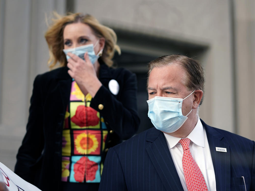 Mark and Patricia McCloskey leave a court hearing Wednesday in St. Louis. The McCloskeys pleaded not guilty to unlawful use of a weapon and tampering with evidence.