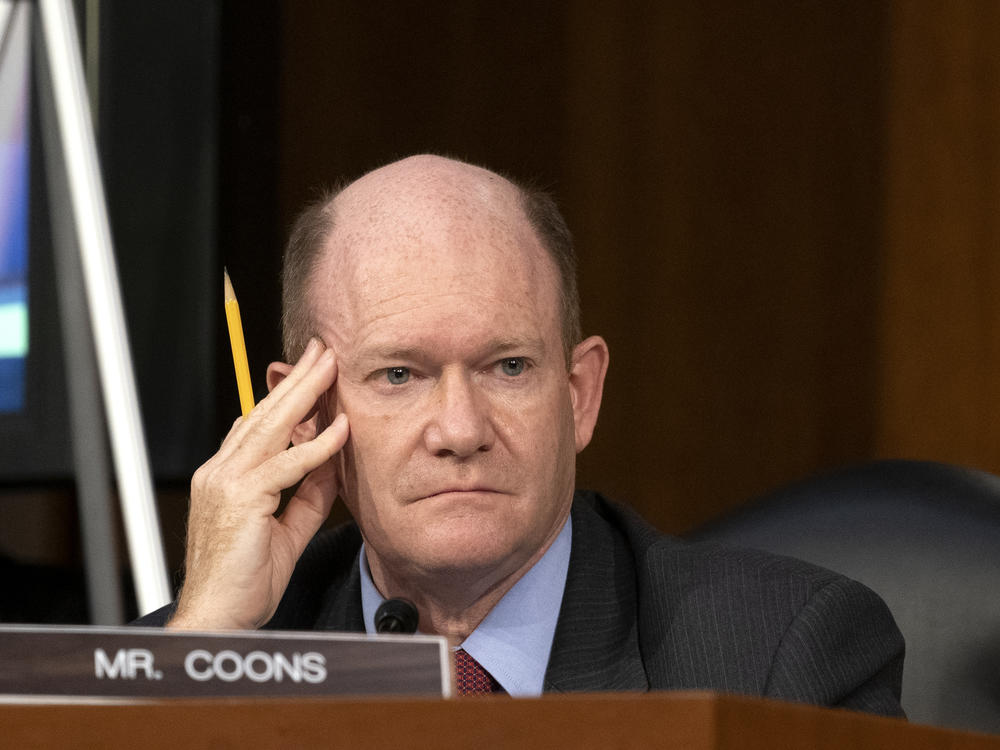 Sen. Chris Coons, D-Del., looks on as Supreme Court nominee Judge Amy Coney Barrett testifies before the Senate Judiciary Committee on the third day of her confirmation hearings.