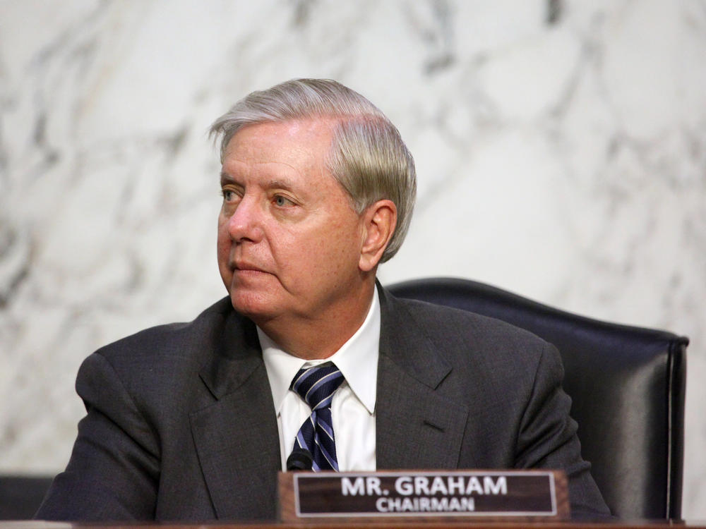 Sen. Lindsey Graham, R-S.C., looks on as Supreme Court nominee Judge Amy Coney Barrett testifies before the Senate Judiciary Committee on the third day of her confirmation hearing.