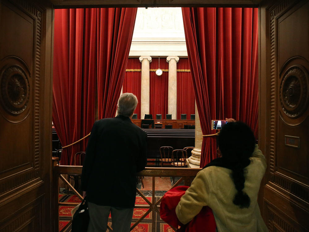 Tourists look into the chamber of the U.S. Supreme Court in February 2016.