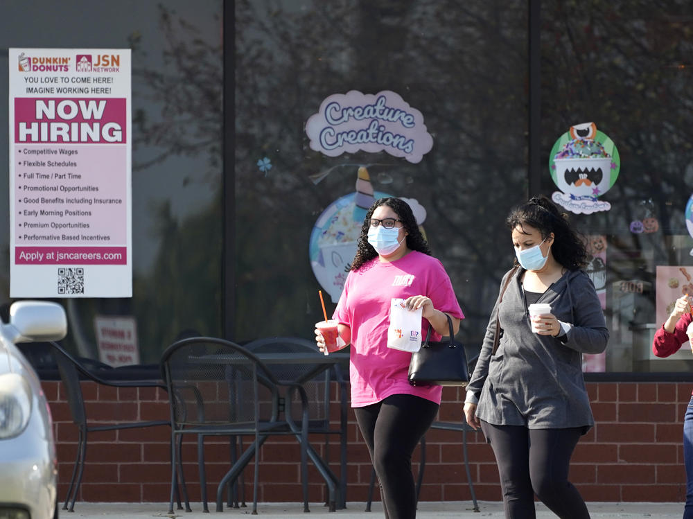 People wear face masks as they leave a store in Vernon Hills, Ill., last week. State health officials say the number of coronavirus cases and COVID-19 deaths in the state are hitting worrisome new highs.