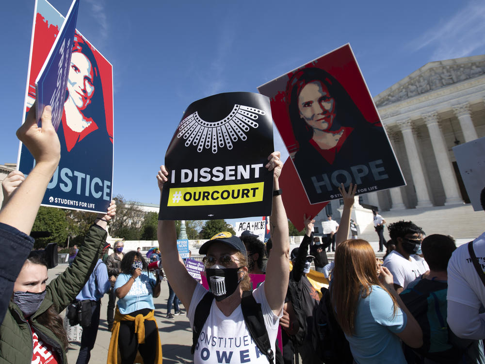 Supporters and opponents of the confirmation of Judge Amy Coney Barrett rally Wednesday at the Supreme Court. On Thursday, witnesses will speak at the Senate Judiciary Committee for and against President Trump's nominee to the court.