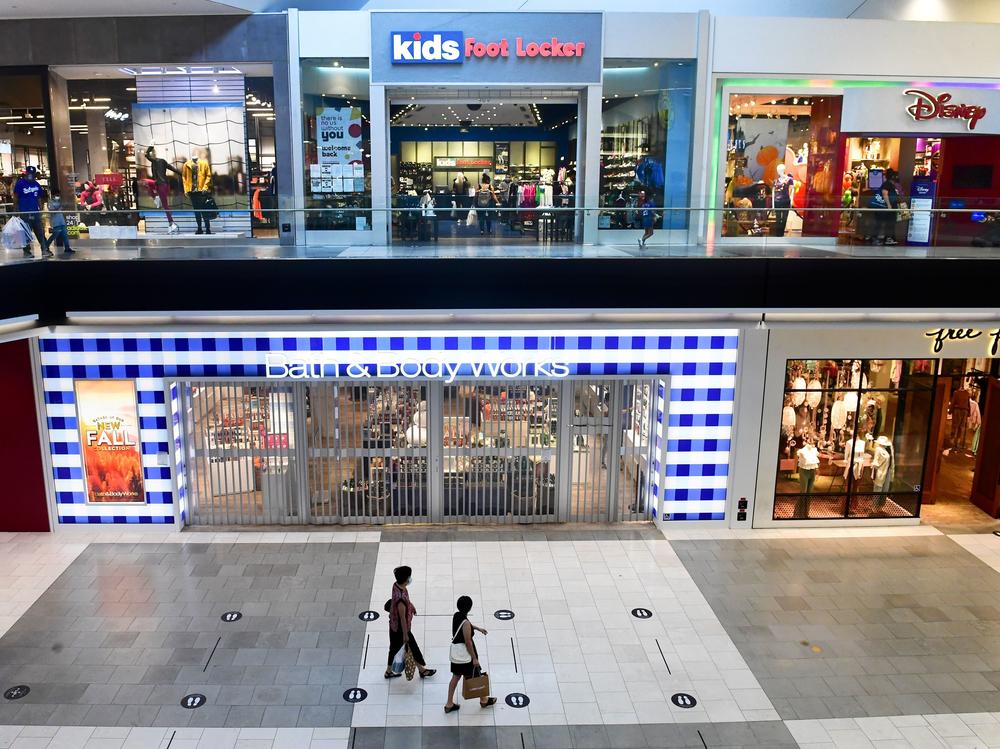 Shoppers stroll through the newly reopened Westfield Santa Anita mall in Arcadia, Calif., on Oct. 7.