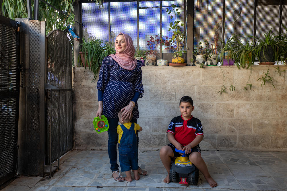 Sawsan al-Ramemi with sons Zain, left, and Omer at home in Amman. She is expecting her third child.