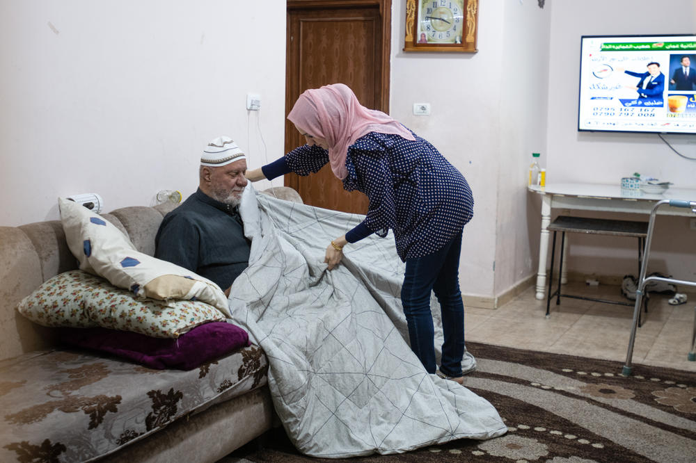 Ramemi attends to her father. She moved in with her parents because her husband is working abroad.