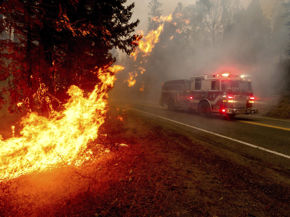 A firetruck drives along state Highway 168 last month while battling the Creek Fire in the Shaver Lake community of Fresno County, Calif.