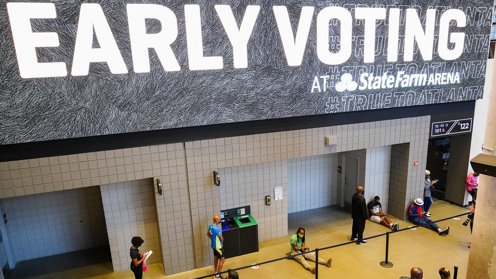 People wait in line to vote early at the State Farm Arena in Atlanta on Monday.