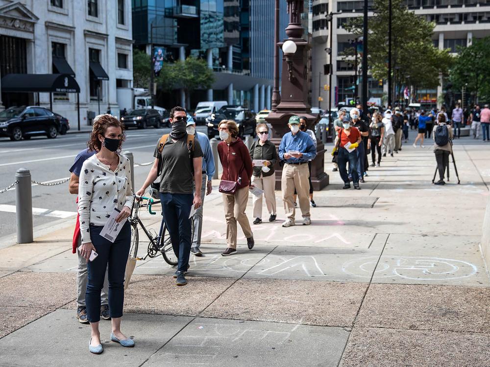 People wait in line to cast their vote during early voting at City Hall in Philadelphia on Oct. 7.