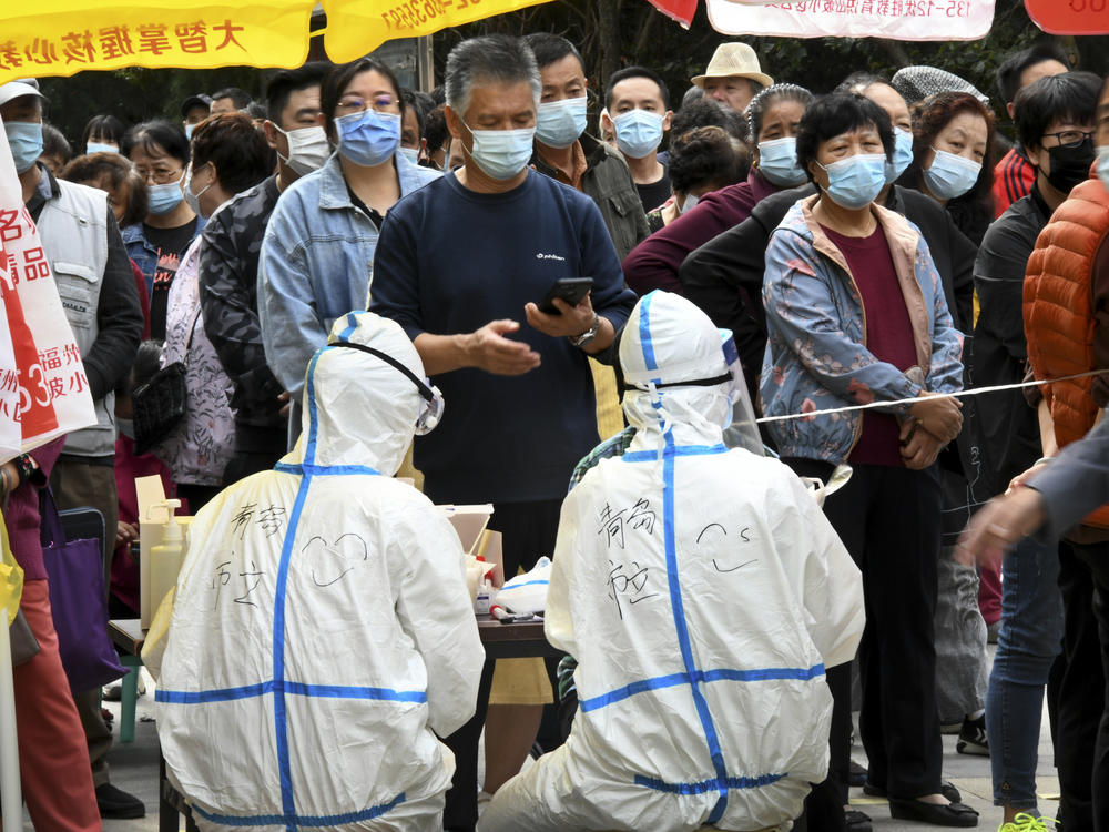 In this photo released by Xinhua News Agency, residents line up for COVID-19 tests in Qingdao this week. China says it has carried out 10 million tests in the northern port city, with no new cases found.