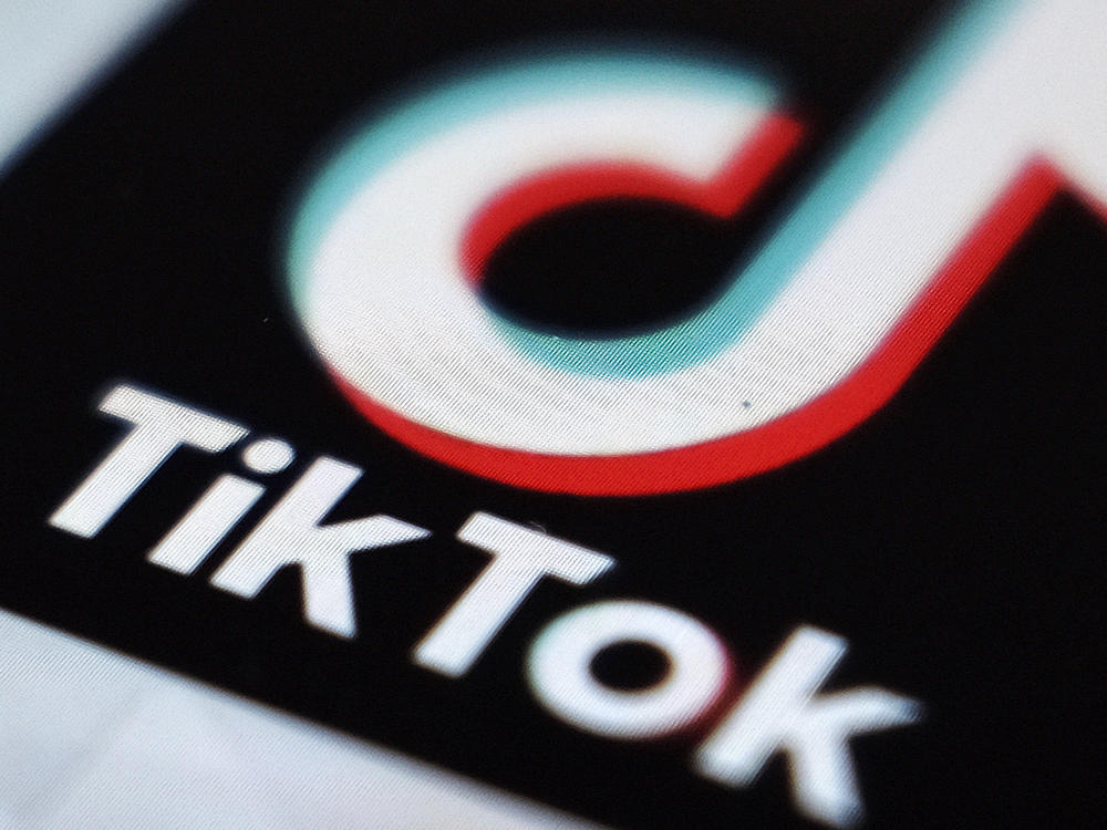 TikTok says it is banning all accounts that share content related to the QAnon conspiracy theory, hardening its previous policy on the far-right movement.