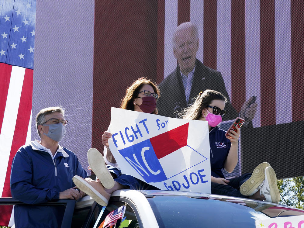 Supporters listen as Democratic presidential nominee Joe Biden speaks during a drive-in campaign event at Riverside High School in Durham, N.C., on Sunday.