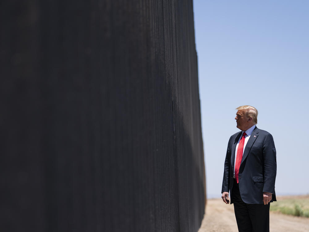 President Trump tours a section of the border wall in San Luis, Ariz., on June 23. The Supreme Court is agreeing to review a Trump administration policy that makes asylum-seekers wait in Mexico for U.S. court hearings.