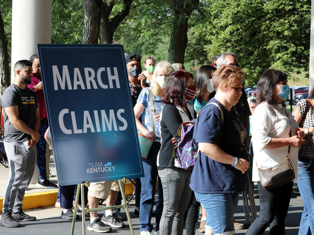 Hundreds of unemployed Kentucky residents wait in long lines outside the Kentucky Career Center in Frankfort for help with their unemployment claims on June 19. New research shows savings built up by the jobless are starting to run out.