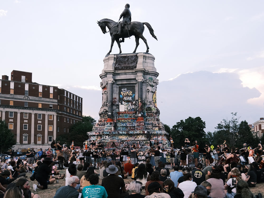 The Robert E. Lee statue on Richmond's Monument Avenue is seen here during a violin vigil to remember Elijah McClain in July.