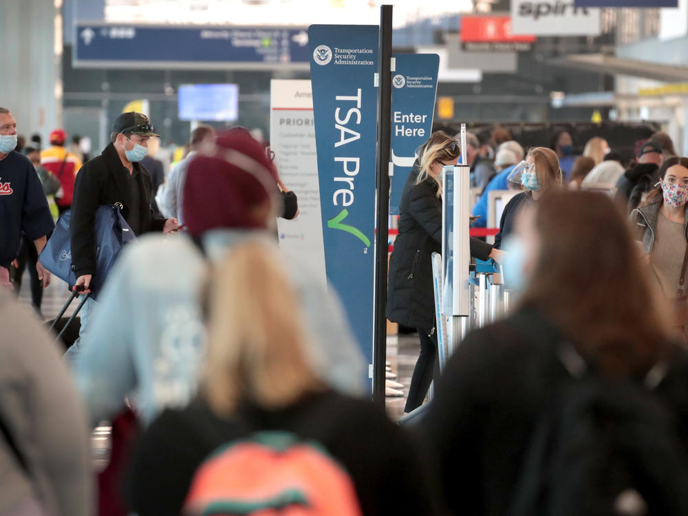 Passengers enter a checkpoint at O'Hare International Airport on Monday. The TSA reports it screened over 1 million passengers on Sunday, the highest number since the coronavirus crisis began.
