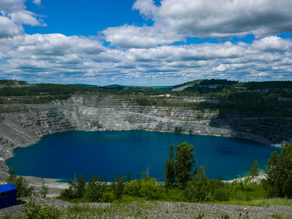 A photo taken in July shows what's left of the Jeffrey asbestos mine in Asbestos, Quebec. The town has voted to change its name to Val-des-Sources.