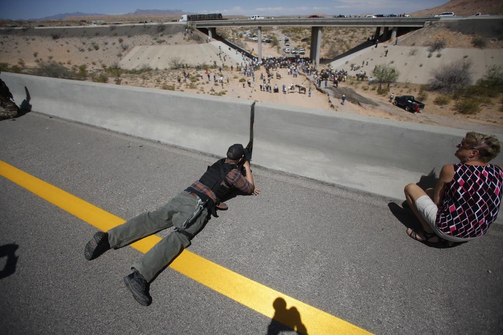 Eric Parker points his rifle from a bridge during an armed standoff with the federal government near Bunkerville, Nev., on April 12, 2014.