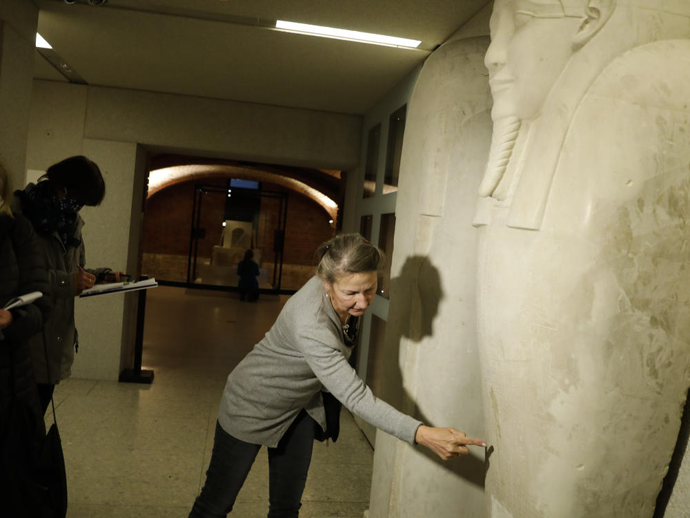 Friederike Seyfried, director of Antique Egyptian Department of the Neues Museum in Berlin, shows media a stain from liquid on the Sarcophagus of the prophet Ahmose on Wednesday.