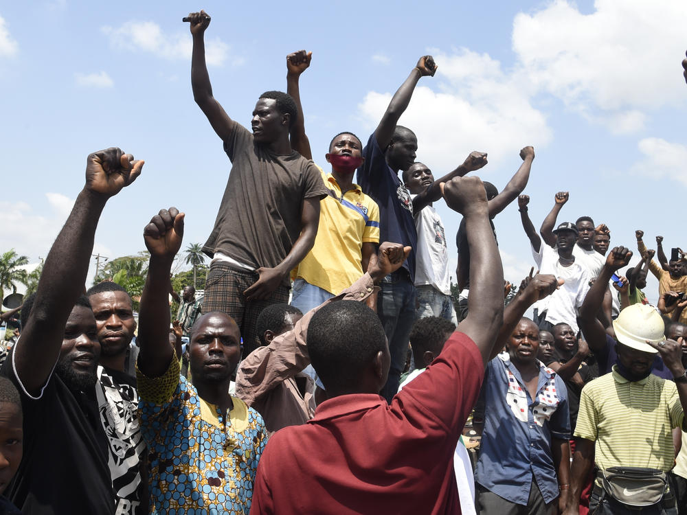 Protesters chant and sing solidarity songs as they barricade barricade the Lagos-Ibadan expressway on Wednesday to protest against police brutality and the killing of protesters by the military, at Magboro, Ogun State, Nigeria.