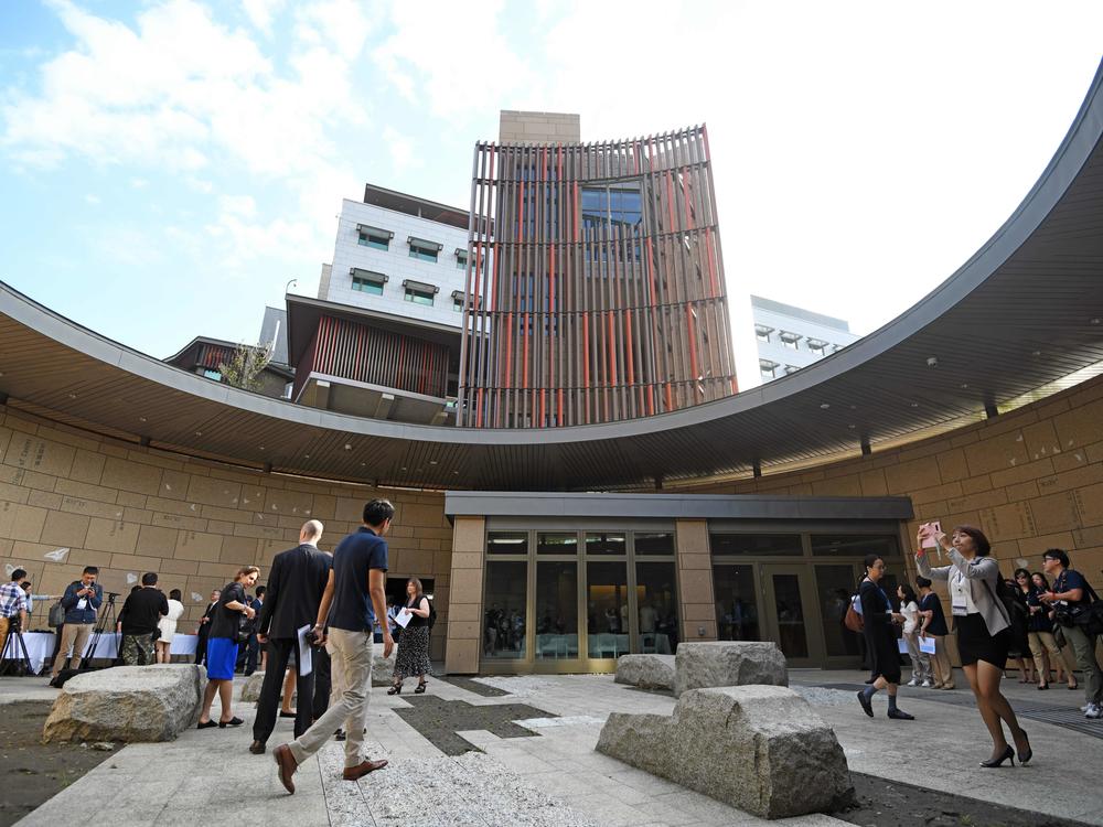 Journalists tour the new office complex of the American Institute in Taiwan during a dedication ceremony in Taipei on June 12, 2018.