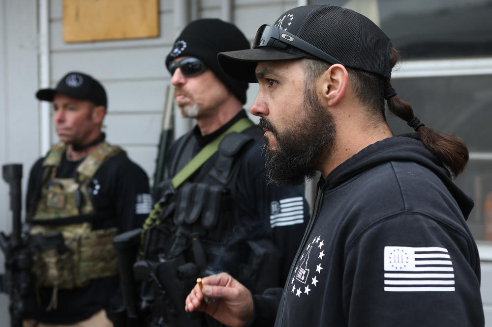 Parker listens with other members after a convoy protection training exercise in January. Even if Parker is a long-shot candidate against a popular, five-term incumbent, the experience gives his ideology a bigger platform, potentially drawing recruits through his boots-to-suits transformation.