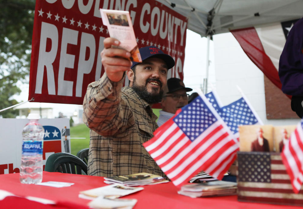 Eric Parker hands out copies of the U.S. Constitution as he campaigns at the Gooding Pro Rodeo in Gooding, Idaho on Sept. 18.
