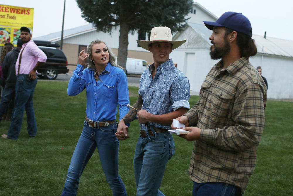 Parker hands out copies of the U.S. Constitution as he campaigns at the Gooding Pro Rodeo.