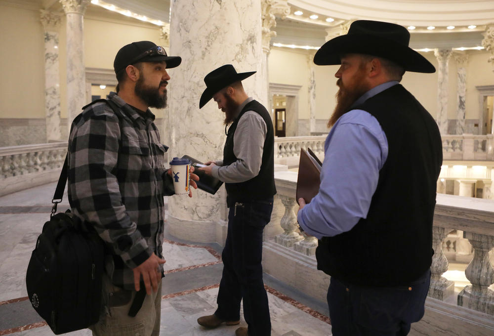 Parker gathers with members of the Real 3%ers Idaho, Nicolas Gatejen and Jordan Marques, before meetings with politicians at the state capitol in Boise on Jan. 24.
