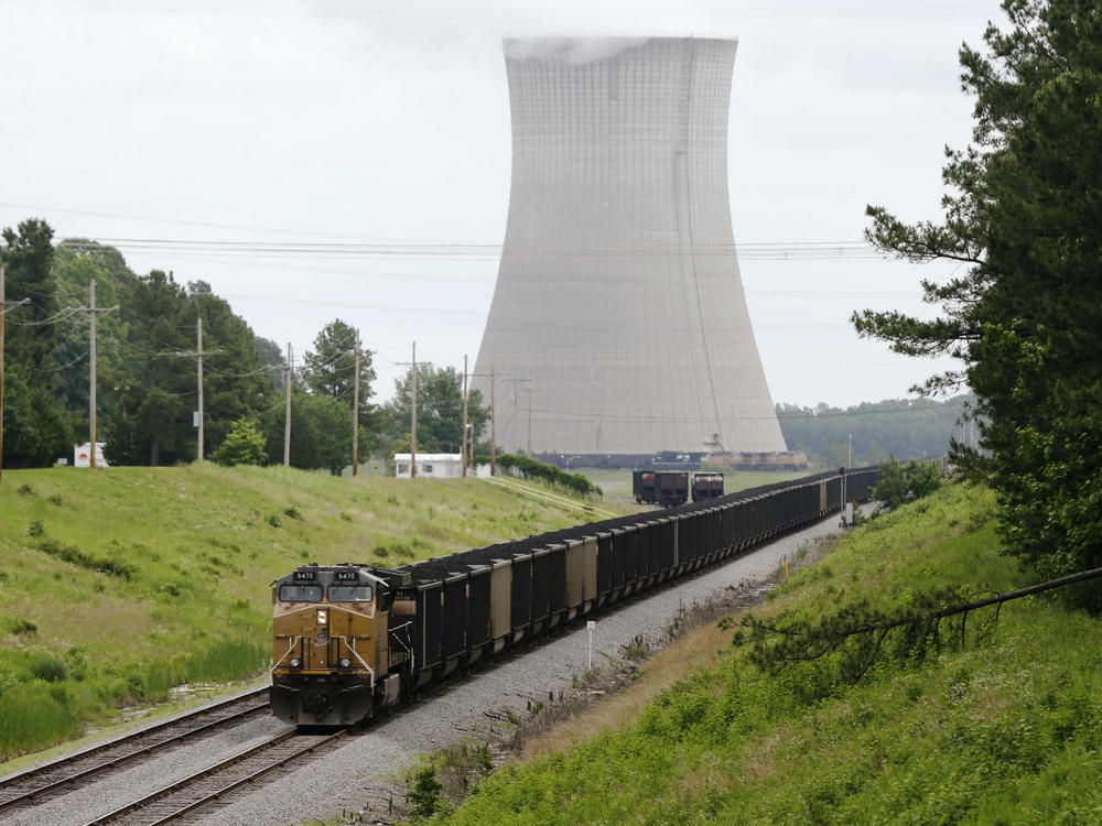 A coal train stops near the White Bluff Plant near Redfield, Ark. in 2014. Entergy Arkansas agreed to eventually stop using coal at this and another plant under a settlement with environmental groups, but a dark money nonprofit funded by Wyoming is pushing to keep them operating.