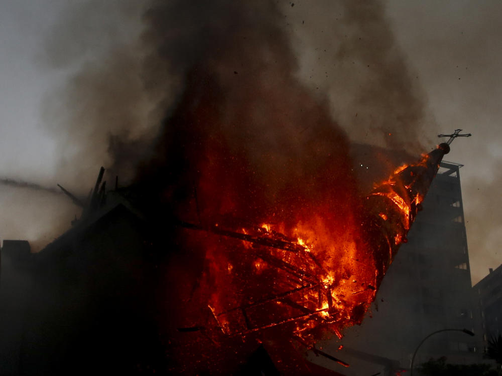 The dome of La Asunción church collapses after it was attacked and set on fire on the first anniversary of the outbreak of anti-government mass protests over inequality in Santiago, Chile, on Oct. 18.