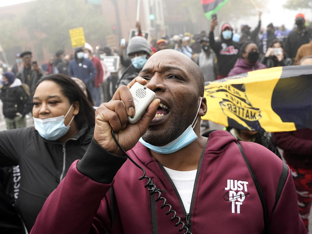 Rayon Edwards rallies protesters during a march Thursday for Marcellis Stinnette, who was killed by police in Waukegan, Ill.